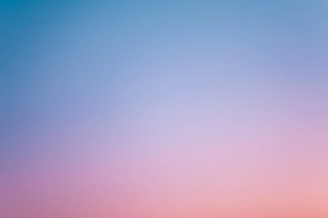 a pink and blue sky with a few clouds