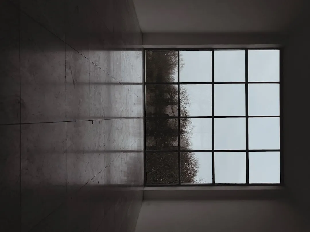 an empty room with a window and a wall