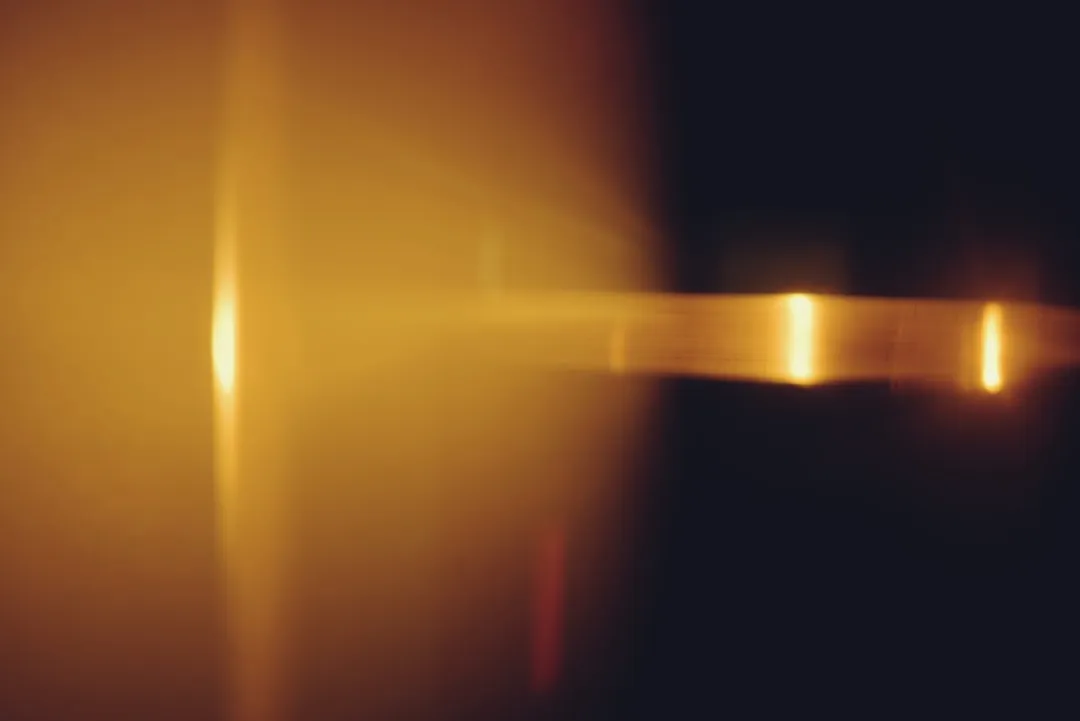 Golden light flares and streaks on dark background