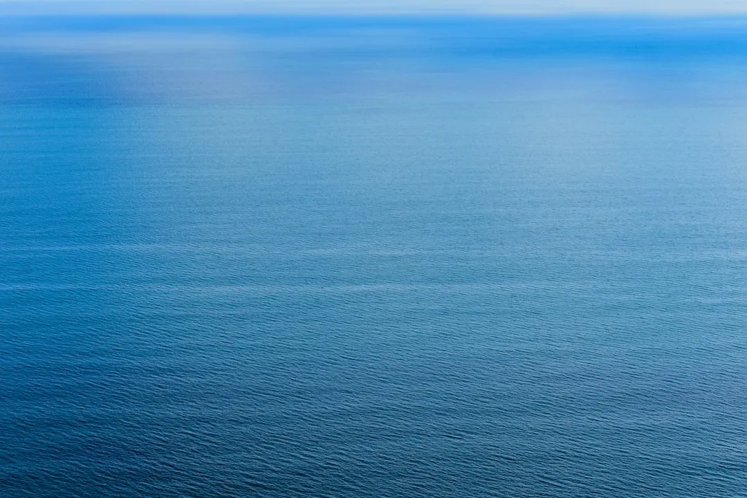 Calm blue ocean water with horizon line on horizon