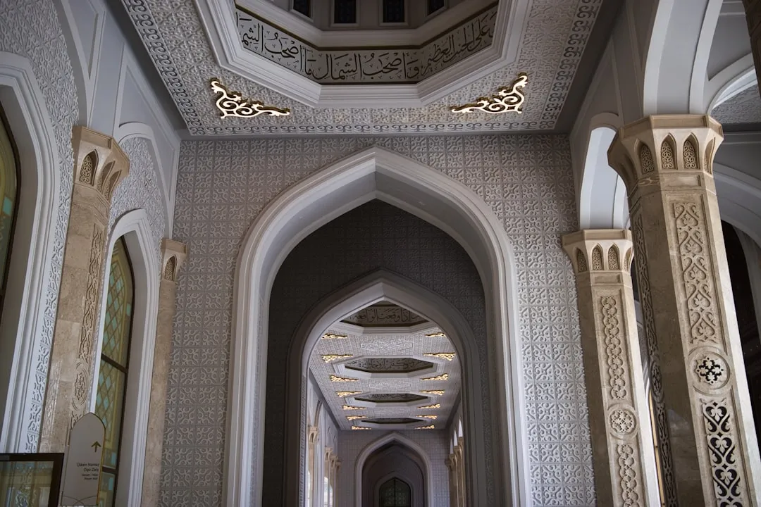Ornate hallway with arched doorways and columns