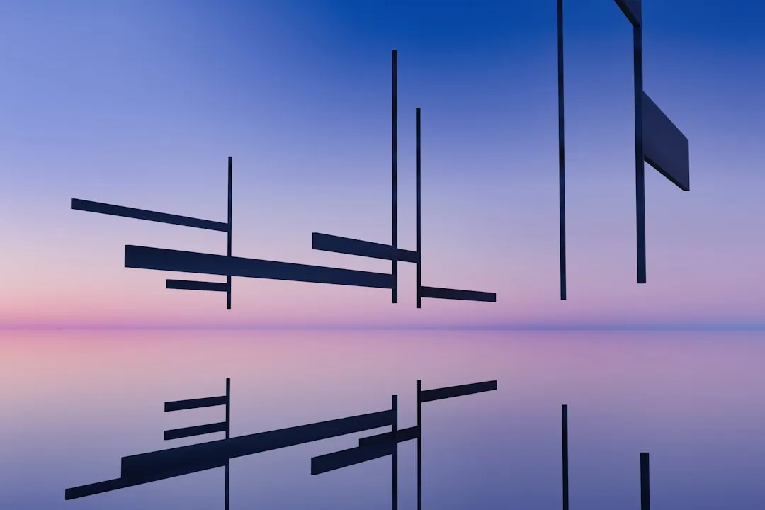 Abstract geometric shapes reflected on water at sunset