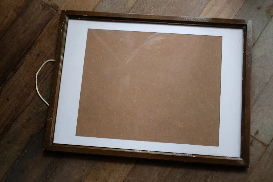 a picture frame sitting on top of a wooden floor