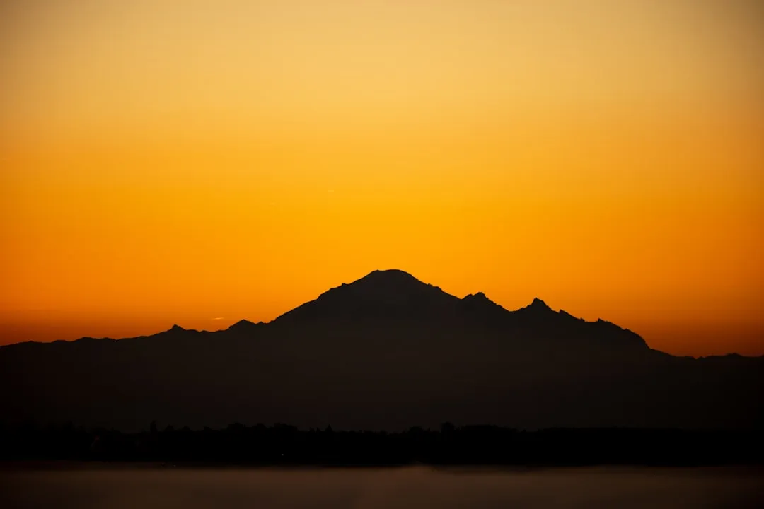 a mountain with a sunset in the background