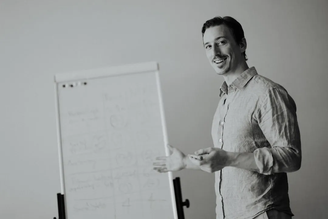 Man presenting by a whiteboard in a studio