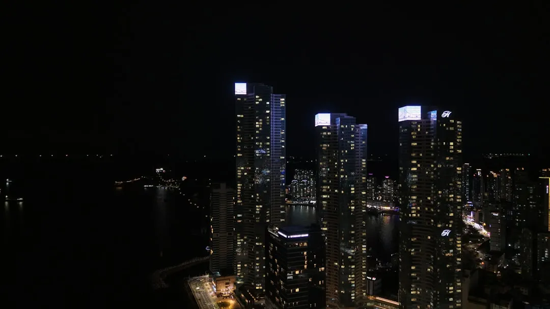 City skyscrapers light up at night.