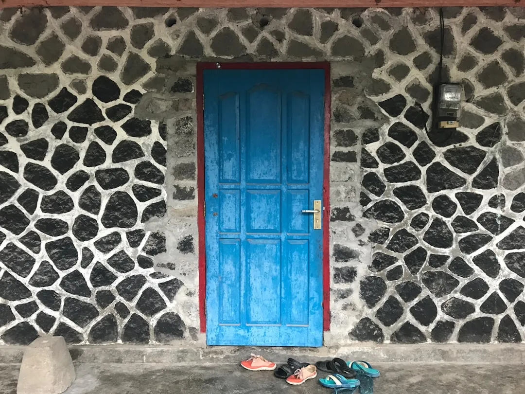 blue wooden door on gray concrete wall