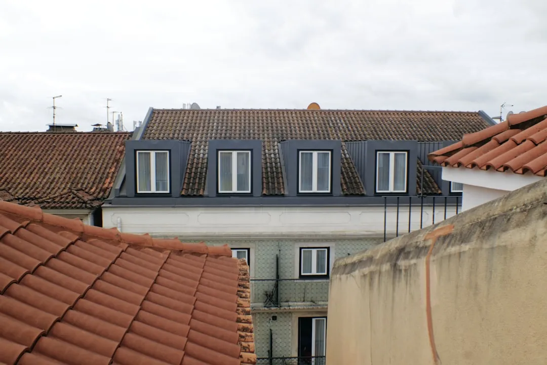 Buildings with tiled roofs and dormer windows.