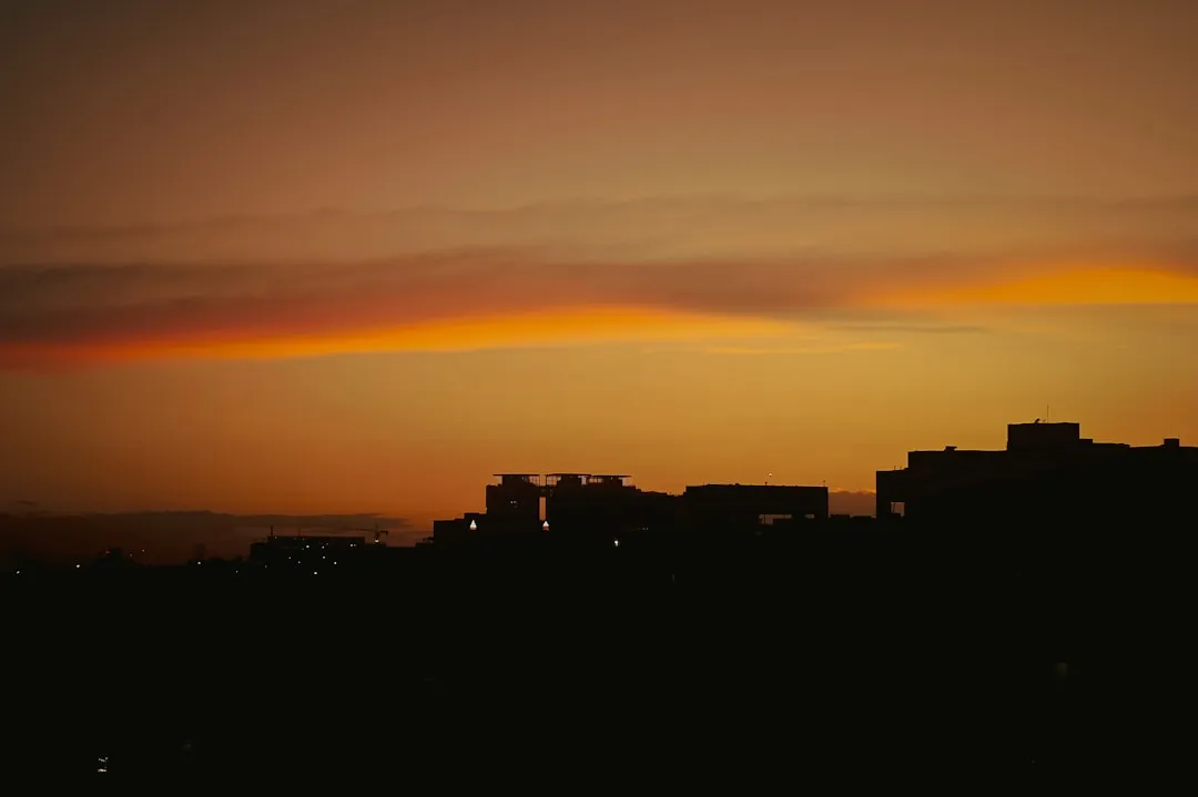 A sunset view of a city from a hill