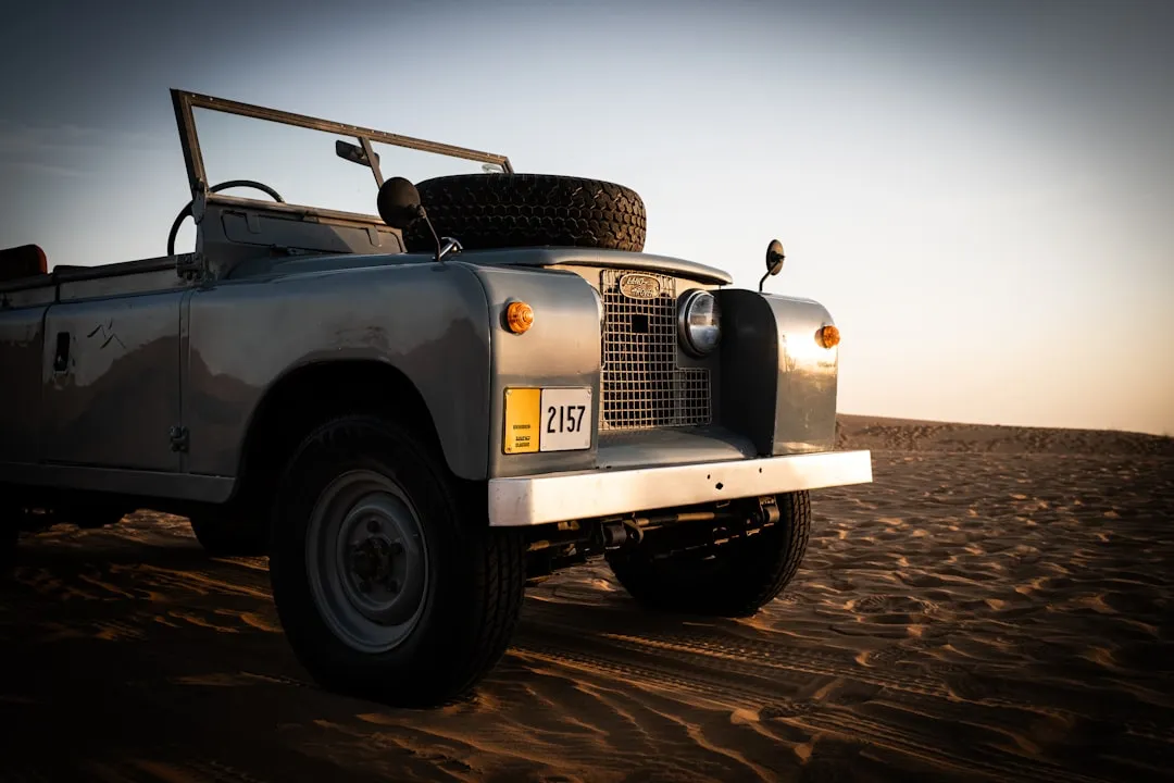 Vintage convertible off-road vehicle in desert at sunset