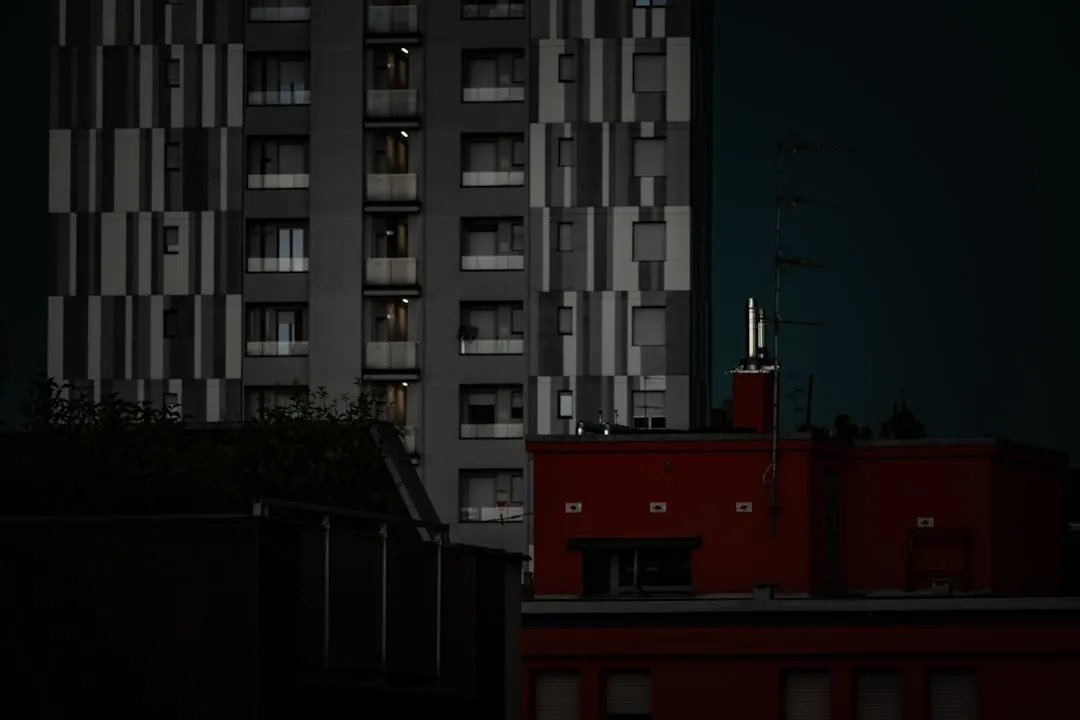 High-rise building sits against a dark sky.