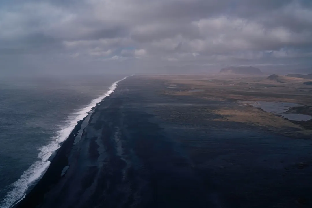A dramatic coastline under a cloudy sky.